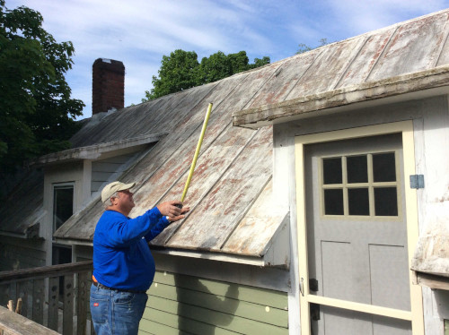 Another before shot of Scott measuring the length of the metal roof.