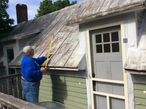 A shot of Scott contemplating a plan of attack to finish scraping the roof.