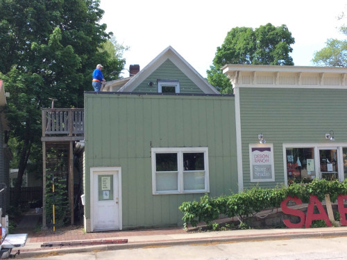 Before photo of Scott getting on the roof of Design Ranch in Iowa City, IA.