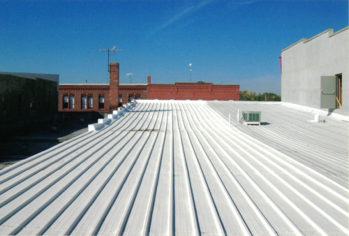 Photo showing half of the lower roof's coating finished.