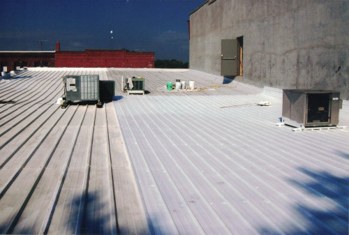 Photo showing the roof coating from 2 years prior and the fresh coating.