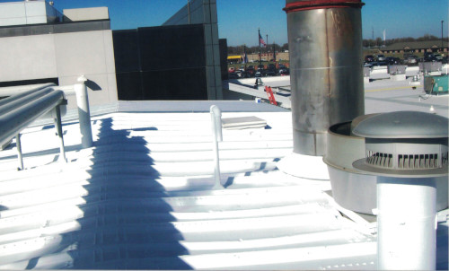 Photo of a commercial building's roof with many obstacles.